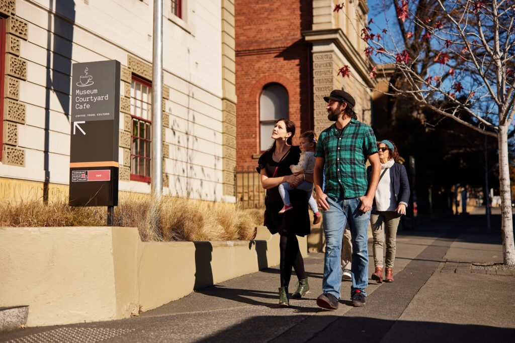 Family walking past the Tasmanian Museum and Art Gallery towards the Museum Courtyard Café in Hobart